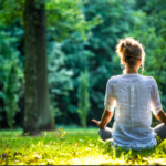 Person practicing mindfulness meditation on a sunny day