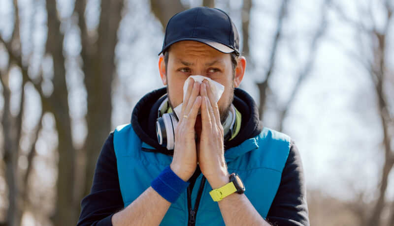 An athlete stops running practice due to a runny nose, blows his nose in a handkerchief. Illness interferes with exercise